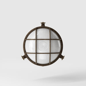 Round outdoor wall lamp in brass with protective grid and glass, marine style for outdoor lighting by Ghidini 1849 - Finish: OAS Antique Brass