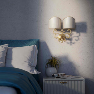 Neoclassical twin brass wall lamp with fleur-de-lis motif and symmetrical scrolls, white pleated shades, elegant Italian design - Finish: OBS Bronze Satin Brass