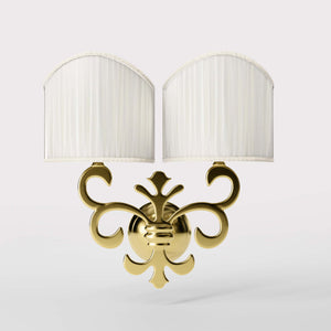 Neoclassical twin brass wall lamp with fleur-de-lis motif and symmetrical scrolls, white pleated shades, elegant Italian design - Finish: OLV Polished Brass