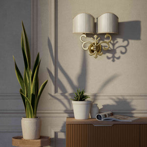 Neoclassical twin brass wall lamp with fleur-de-lis motif and symmetrical scrolls, white pleated shades, elegant Italian design - Finish: OLV Polished Brass