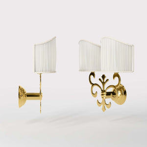 Neoclassical twin brass wall lamp with fleur-de-lis motif and symmetrical scrolls, white pleated shades, elegant Italian design - Finish: ORO 24K Gold Plated
