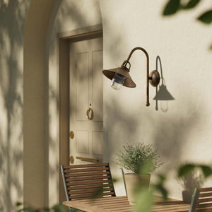 Country style outdoor brass wall lamp with arched arm protective hood and transparent glass diffuser Giada collection by Ghidini 1849 - Finish: OAS Antique Brass