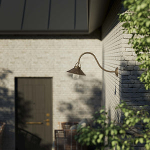 Classic style outdoor brass wall lamp with curved arm conical shade and transparent glass diffuser Giada collection by Ghidini 1849 - Finish: OAS Antique Brass