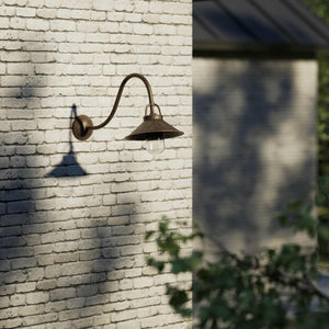 Classic style outdoor brass wall lamp with curved arm conical shade and transparent glass diffuser Giada collection by Ghidini 1849 - Finish: OAS Antique Brass