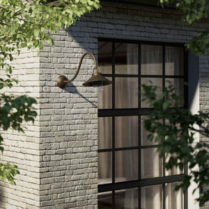 Classic style outdoor brass wall lamp with curved arm conical shade and transparent glass diffuser Giada collection by Ghidini 1849 - Finish: OBM Bronze Satin Matt Brass