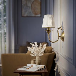 Classic brass wall lamp with pleated ivory white shade, decorative arm and floral details for elegant wall lighting - Finish: OBS Bronze Satin Brass