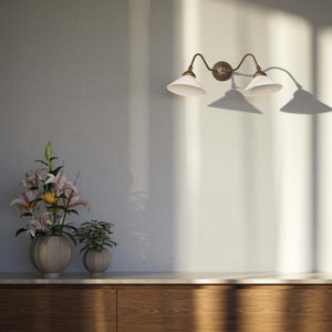 Vintage style wall lamp in brass with curved arm and white glass shade, Sofia collection of Italian craftsmanship by Ghidini 1849 - Finish: OAS Antique Brass