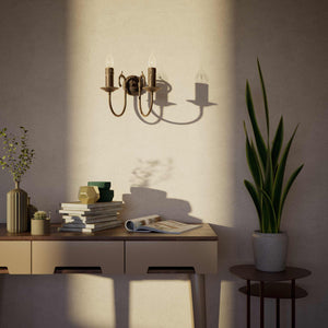 Classic double wall lamp in brass with fan-decorated central rosette, intertwined arms and lamp holders with dripping wax pattern by Ghidini 1849 - Finish: OAS Antique Brass