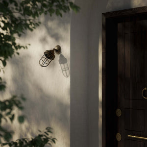 Rustic outdoor wall light in brass with clear glass shade, industrial maritime design, and adjustable joint by Ghidini 1849 - Finish: OAS Antique Brass