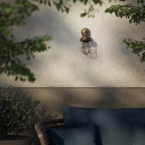 Rustic outdoor wall light in brass with clear glass shade, industrial maritime design, and adjustable joint by Ghidini 1849 - Finish: OAS Antique Brass