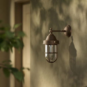Outdoor wall lamp in brass with a transparent glass cage, industrial style, weather-resistant by Ghidini 1849 - Finish: OBM Bronze Satin Matt Brass