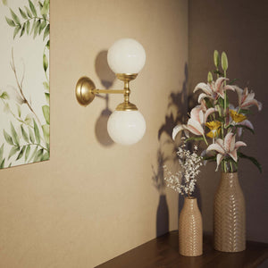 Art Deco wall sconce with two opal glass spheres and brass structure, classic and elegant Italian design for interior lighting - Finish: OBS Bronze Satin Brass