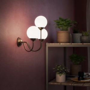 Brass wall lamp with three glossy white glass globes, elegant design, interior lighting by Ghidini 1849 - Finish: OBM Bronze Satin Matt Brass