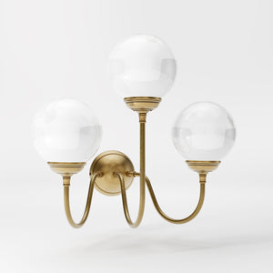 Brass wall lamp with three glossy white glass globes, elegant design, interior lighting by Ghidini 1849 - Finish: OBS Bronze Satin Brass