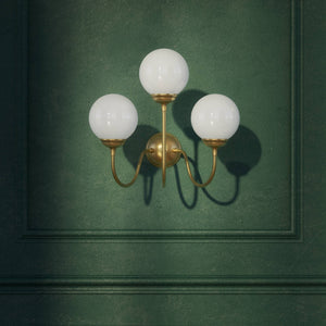 Brass wall lamp with three glossy white glass globes, elegant design, interior lighting by Ghidini 1849 - Finish: OBS Bronze Satin Brass