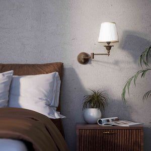 Classic brass wall lamp with adjustable arm and ivory fabric shade, gold decorative trim, floral rosette base London - Finish: OAS Antique Brass