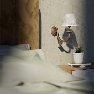 Classical brass wall lamp with decorated white fabric shade, curved arm and ornamental rosette, traditional floral details - Finish: OAS Antique Brass