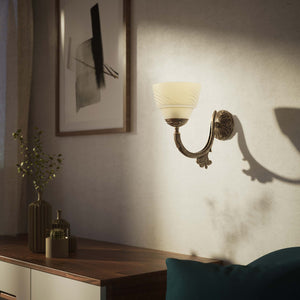 Art Nouveau brass wall lamp with floral decorated arm and frosted glass diffuser with geometric diamond pattern by Ghidini 1849 - Finish: OAS Antique Brass