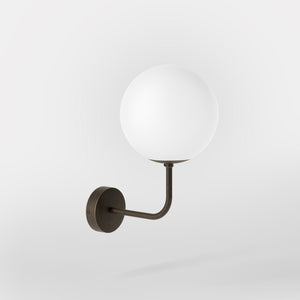 Art Deco wall sconce with frosted glass sphere and curved brass arm, Made in Italy design by Ghidini 1849 - Finish: OBM Bronze Satin Matt Brass
