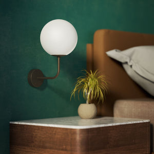 Art Deco wall sconce with frosted glass sphere and curved brass arm, Made in Italy design by Ghidini 1849 - Finish: OBM Bronze Satin Matt Brass