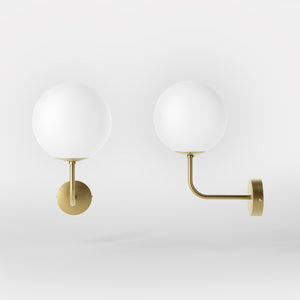 Art Deco wall sconce with frosted glass sphere and curved brass arm, Made in Italy design by Ghidini 1849 - Finish: OBV Bronze Satin Light Brass
