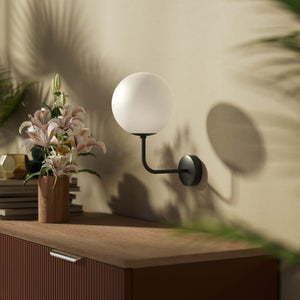 Art Deco wall sconce with frosted glass sphere and curved brass arm, Made in Italy design by Ghidini 1849 - Finish: ONO Matt Black