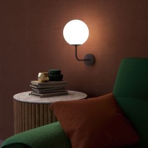 Art Deco wall sconce with frosted glass sphere and curved brass arm, Made in Italy design by Ghidini 1849 - Finish: ONO Matt Black