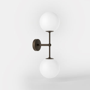 Modern wall light with two frosted glass spheres and vertical brass structure Made in Italy design by Ghidini 1849 - Finish: OBM Bronze Satin Matt Brass