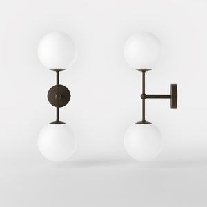 Modern wall light with two frosted glass spheres and vertical brass structure Made in Italy design by Ghidini 1849 - Finish: OBM Bronze Satin Matt Brass