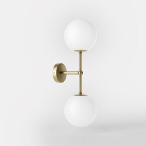 Modern wall light with two frosted glass spheres and vertical brass structure Made in Italy design by Ghidini 1849 - Finish: OBV Bronze Satin Light Brass