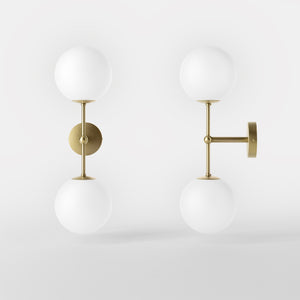 Modern wall light with two frosted glass spheres and vertical brass structure Made in Italy design by Ghidini 1849 - Finish: OBV Bronze Satin Light Brass