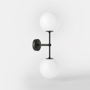 Modern wall light with two frosted glass spheres and vertical brass structure Made in Italy design by Ghidini 1849 - Finish: ONO Matt Black