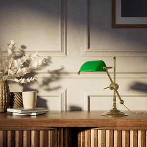 Mini brass desk lamp with green glass shade sliding arm on stem and turned circular base by Ghidini 1849 - Finish: OLV Polished Brass