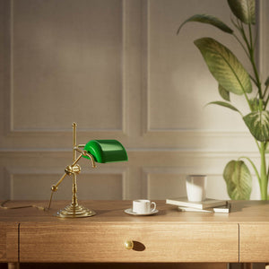 Mini brass desk lamp with green glass shade sliding arm on stem and turned circular base by Ghidini 1849 - Finish: OLV Polished Brass
