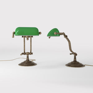Compact brass desk lamp with green glass shade double joint system and stepped circular base by Ghidini 1849 - Finish: OAS Antique Brass