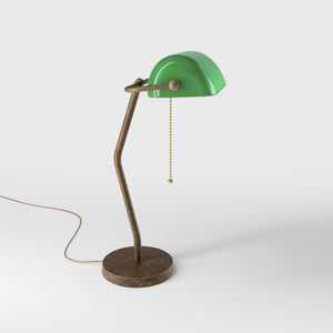 Minimalist table lamp with green glass shade circular brass base slender stem and pull chain by Ghidini 1849 - Finish: OAS Antique Brass