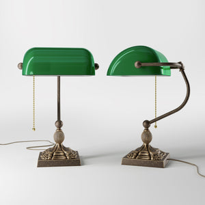 Banker’s lamp in brass with green glass shade, decorative base, and pull-chain switch. Elegant desk or decorative lighting by Ghidini 1849 - Finish: OAS Antique Brass