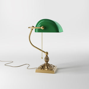 Banker’s lamp in brass with green glass shade, decorative base, and pull-chain switch. Elegant desk or decorative lighting by Ghidini 1849 - Finish: OBS Bronze Satin Brass
