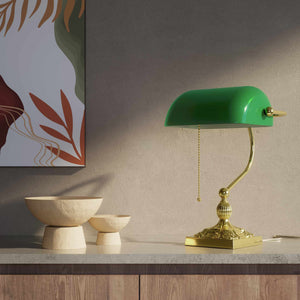 Banker’s lamp in brass with green glass shade, decorative base, and pull-chain switch. Elegant desk or decorative lighting by Ghidini 1849 - Finish: OLV Polished Brass