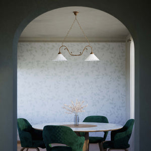 Art Nouveau pendant lamp with two pierced white ceramic shades, decorative brass arms and adjustable suspension chain by Ghidini 1849 - Finish: OAS Antique Brass