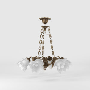 Art Nouveau chandelier with six brass putti and rose-shaped frosted glass shades, decorated chains and floral rosette by Ghidini 1849 - Finish: OAS Antique Brass