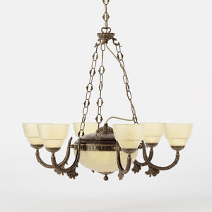 Neoclassical brass chandelier with six decorated arms, central bowl and ornamental chains, diamond-patterned frosted glass diffusers by Ghidini 1849 - Finish: OAS Antique Brass