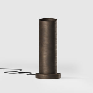 Brass table lamp with a sleek cylindrical shape and circular base, ideal for contemporary and elegant interiors by Ghidini 1849 - Finish: OBM Bronze Satin Matt Brass