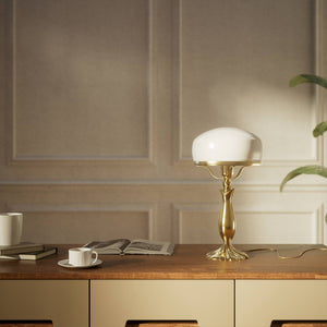 Art Deco table lamp with glossy white mushroom glass shade, sculpted brass base with undulating motifs, Italian design by Ghidini 1849 - Finish: OLV Polished Brass