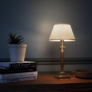Classic brass table lamp with an ivory fabric shade, featuring an ornate column base, ideal for living rooms or office spaces by Ghidini 1849 - Finish: OAS Antique Brass