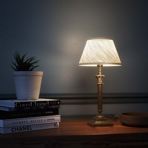 Classic brass table lamp with an ivory fabric shade, featuring an ornate column base, ideal for living rooms or office spaces by Ghidini 1849 - Finish: OAS Antique Brass