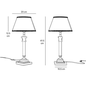 Classic brass table lamp with an ivory fabric shade, featuring an ornate column base, ideal for living rooms or office spaces by Ghidini 1849