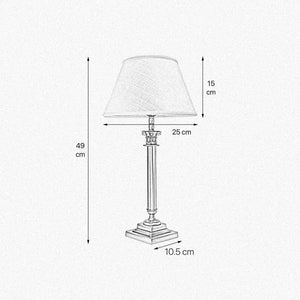 Brass table lamp with classic fabric shade in ivory white, decorative capital detail, ideal for elegant and timeless interiors