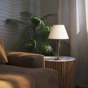 Art Nouveau table lamp Simona collection with decorated brass base featuring floral motifs and pleated ivory white fabric lampshade by Ghidini 1849 - Finish: OAS Antique Brass