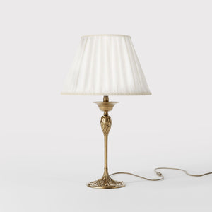 Art Nouveau table lamp Simona collection with decorated brass base featuring floral motifs and pleated ivory white fabric lampshade by Ghidini 1849 - Finish: OBS Bronze Satin Brass